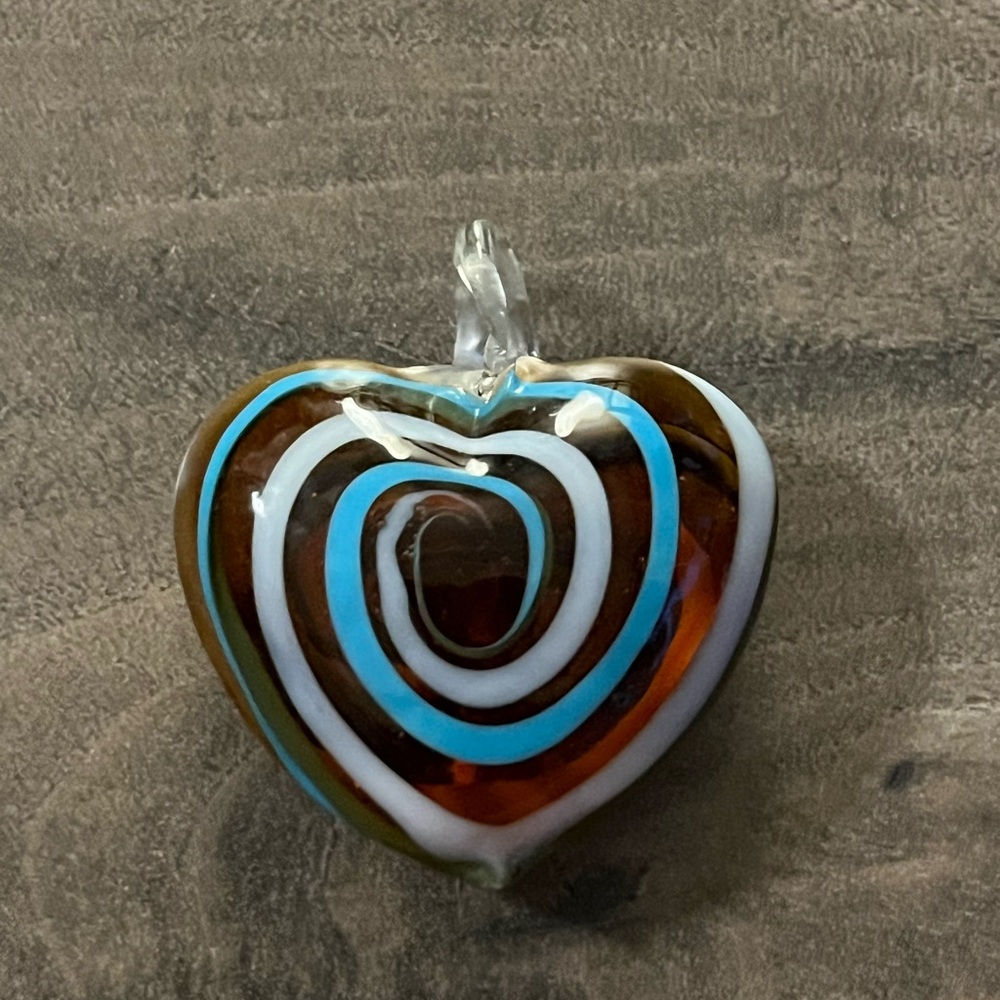 Murano style glass heart pendant with colors of white, brown and blue.